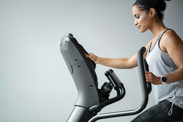 VF23_LIFESTYLE_LC female working out_elliptical_profile close_lores